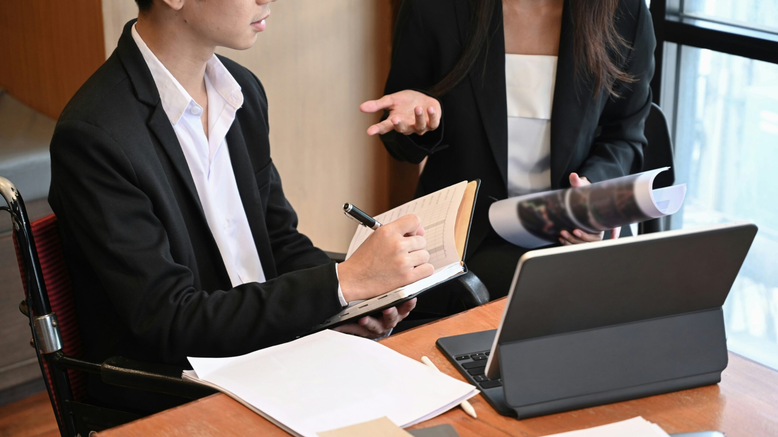 Salt Lake City Estate Planning Lawyer Two professionals at a desk with notes and a laptop