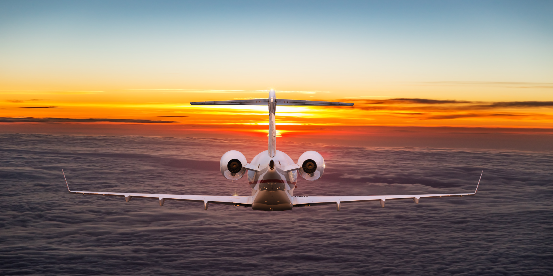 Private jet flying above the clouds at sunset for FAA Part 91 and Part 135 operations